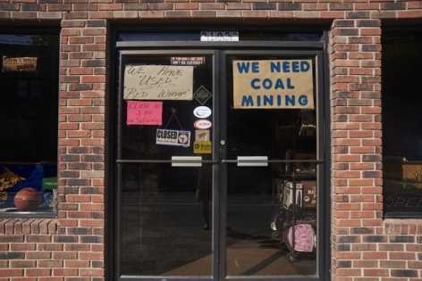 Stacy Kranitz  Hyden, Kentucky, 2015  Archival Pigment Print, 16h x 24w inches, Edition of 5  30 x 40 inches, Edition of 3, exterior street scene of a shop catering to miners, brick facade with signs on the glass double doors