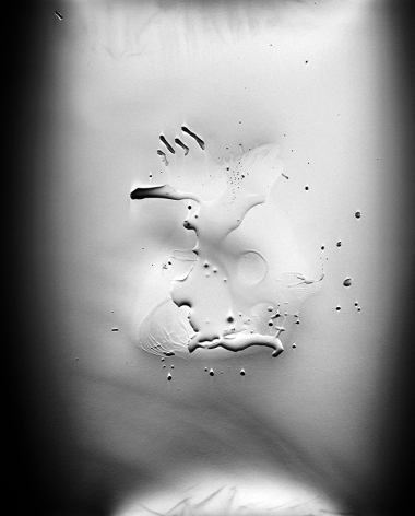 Ben Nixon  The Watcher, 2015  unique silver gelatin photogram  20h x 16w in   Framed: 24h x 20w in. a photogram with a soft vignette with droplets reminiscent of a hand like figure