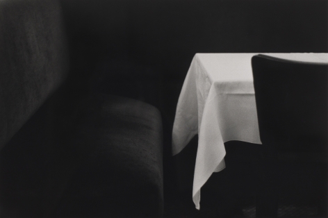 Bernard Plossu (1945-)  Paris, 1973  Vintage Gelatin silver print  12 x 16 inches (paper), vintage black and white photograph of a black banquet and the corner fold of a white table cloth