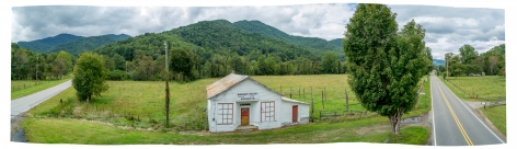 Ken Abbott  Murchison Grocery, Yancey County, NC, 2017  Archival Pigment Print  11 1/2h x 38 1/2w in, panoramic image of an old country store surrounded by rolling hills