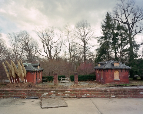 Jade Doskow  Philadelphia 1876 World's Fair, Centennial Exposition, Fair Washrooms, 2008  Archival Pigment Print  20h x 25w inches a photograph of two small buildings with small leafless trees in the background